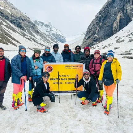 Hampta pass trek 2025 completion group photo with stunning mountain valley backdrop