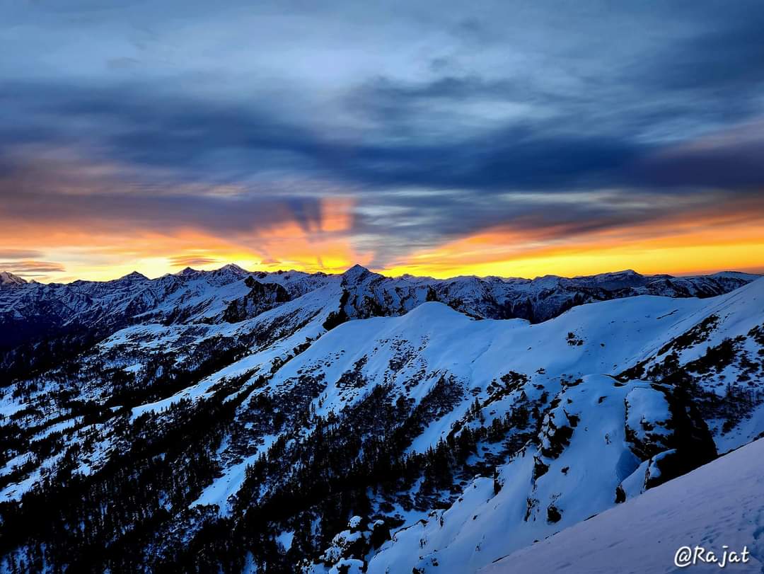 Kedarkantha on Sunset – Breathtaking view of Kedarkantha Peak at sunset, with golden light casting over the snow-covered Himalayas.